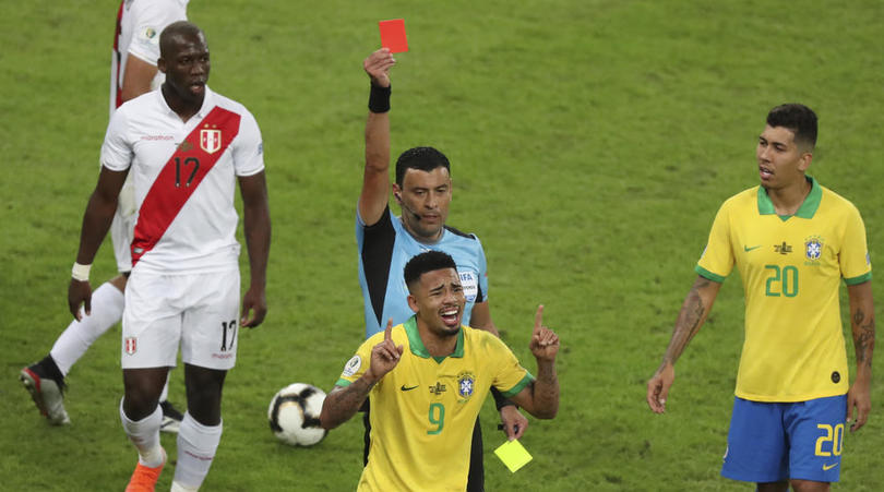 Referee Roberto Tobar shows the red card to Gabriel Jesus of Brazil