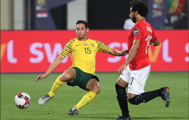 Dean Furman of Bafana Bafana challenges Mohamed Salah of Egypt