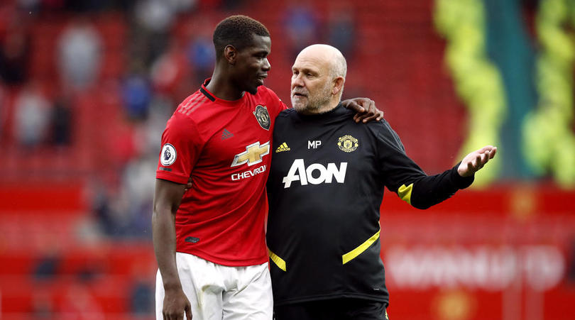 Manchester United's Paul Pogba and assistant manager Mike Phelan (right) after the Premier League match at Old Trafford, Manchester.