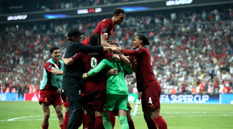 Liverpool players mob new goalkeeper Adrian as they celebrate winning the Super Cup