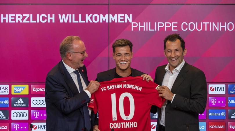 New player for Bayern Munich Philippe Coutinho, center, holds up a team shirt with his name on it with Karl-Heinz Rummenigge, left, and coach Hasan Salihamidzic during a presser in their stadium in Munich, Germany, Monday, Aug. 19, 2019. Coutinho comes as a loaner for one year from FC Barcelona. (Peter Kneffel/dpa via AP)