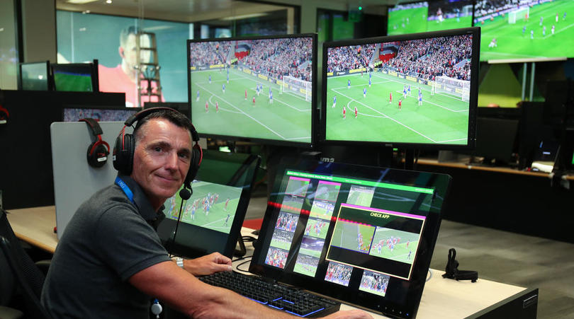 Former Premier League Referee Neil Swarbrick sits at a VAR station within the VAR Hub at Premier League Productions, Stockley Park, London.