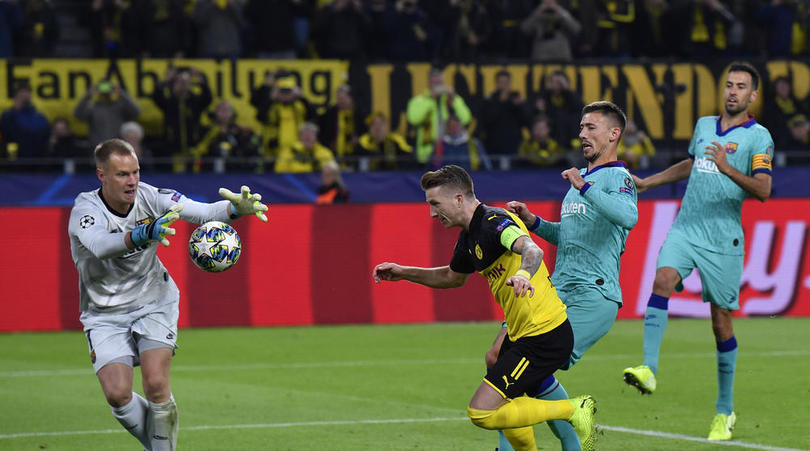 Barcelona's goalkeeper Marc-Andre ter Stegen, left, catches the ball after Dortmund's Marco Reus misses to score on a penalty kick during the Champions League Group F soccer match between Borussia Dortmund and FC Barcelona in Dortmund, Germany,