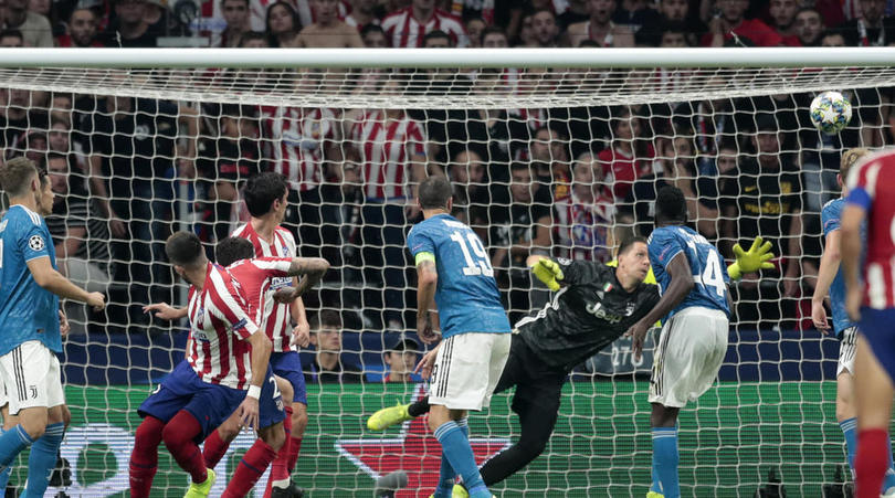 Atletico Madrid's Hector Herrera watches as his header goes into the net passing Juventus' goalkeeper Wojciech Szczesny to score his side's second goal during the Champions League Group D soccer match between Atletico Madrid and Juventus at the Wanda Metropolitano stadium in Madrid, Spain, Wednesday, Sept. 18, 2019. (AP Photo/Bernat Armangue)