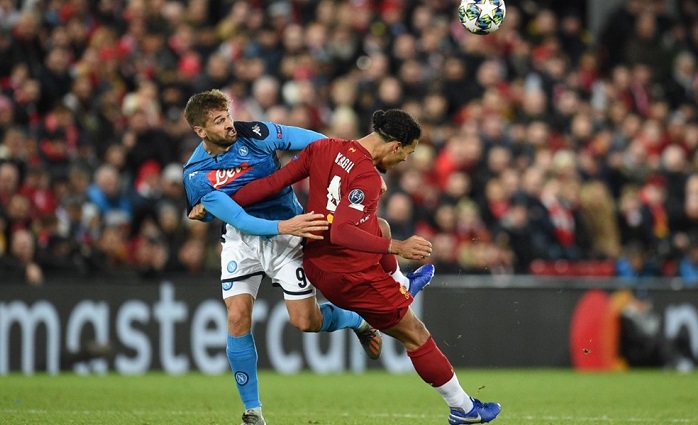 Liverpool defender Virgil van Djik and Napoli striker Fernando Llorente battle for the ball