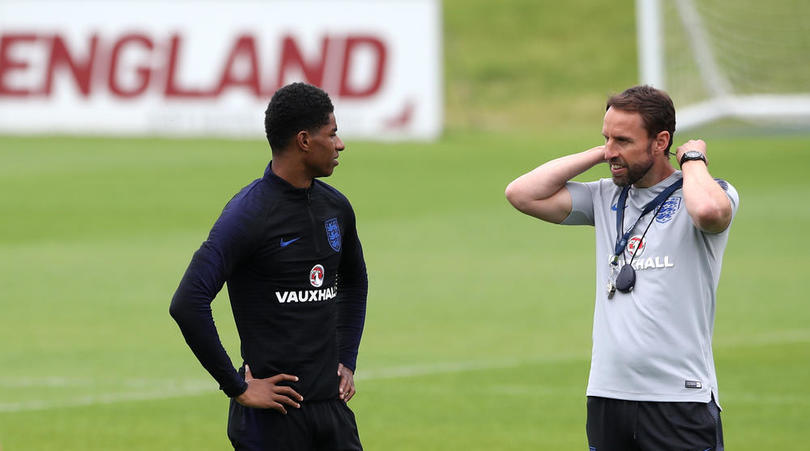 England manager Gareth Southgate speaks to Marcus Rashford during a training session at St George's Park, Burton.