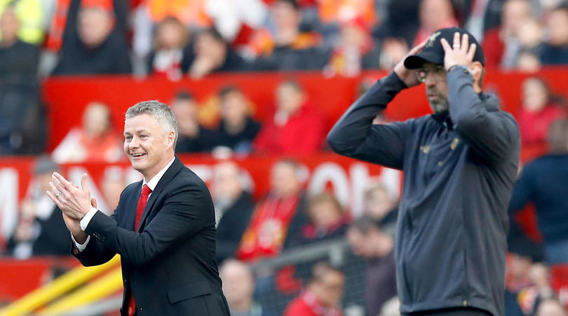 Manchester United caretaker manager Ole Gunnar Solskjaer (left) and Liverpool manager Jurgen Klopp react from the touchline during the Premier League match at Old Trafford, Manchester.