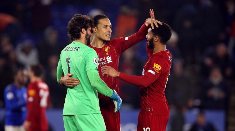 Liverpool's Virgil van Dijk, Joe Gomez (right) and goalkeeper Alisson (left) celebrate after the match