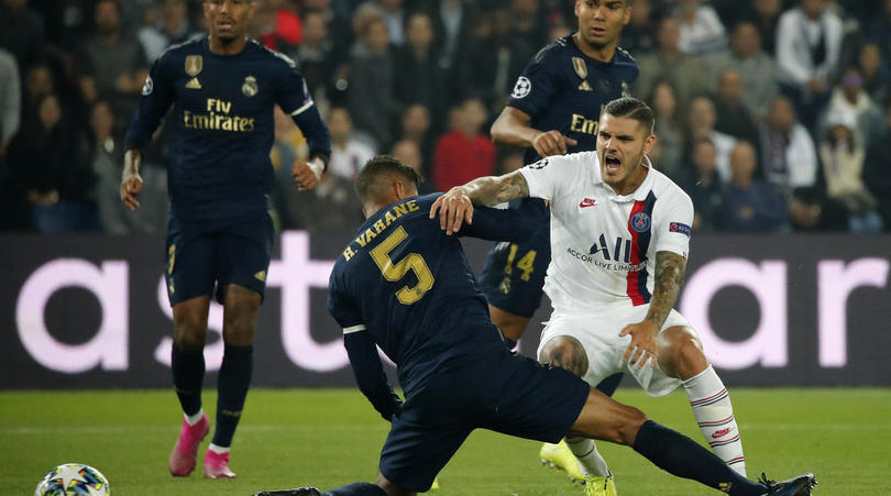 PSG's Mauro Icardi, right, is tackled by Real Madrid's Raphael Varane during a Champions League match