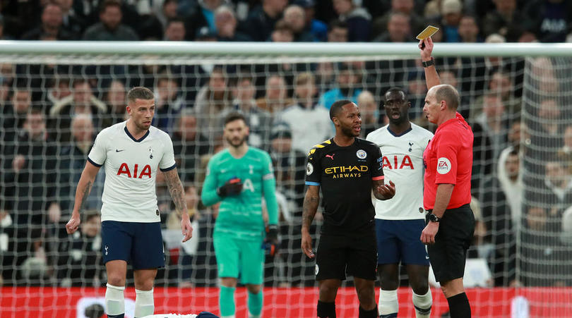 Manchester City's Raheem Sterling is booked for a challenge on Tottenham Hotspur's Dele Alli during the Premier League match at Tottenham Hotspur Stadium, London.