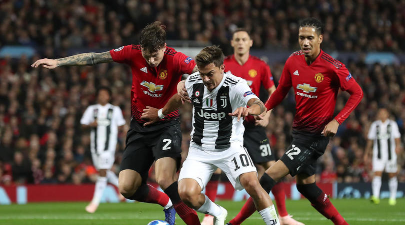 Manchester United's Victor Lindelof and Juventus' Paulo Dybala battle for the ball during the UEFA Champions League match at Old Trafford, Manchester.