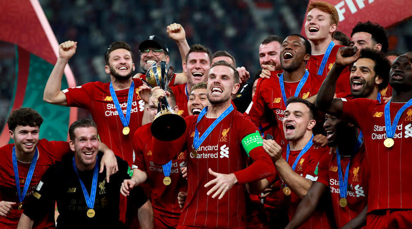 Liverpool's Jordan Henderson celebrates with the trophy after the FIFA Club World Cup final at the Khalifa International Stadium, Doha.